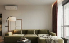 A living room with a large green couch